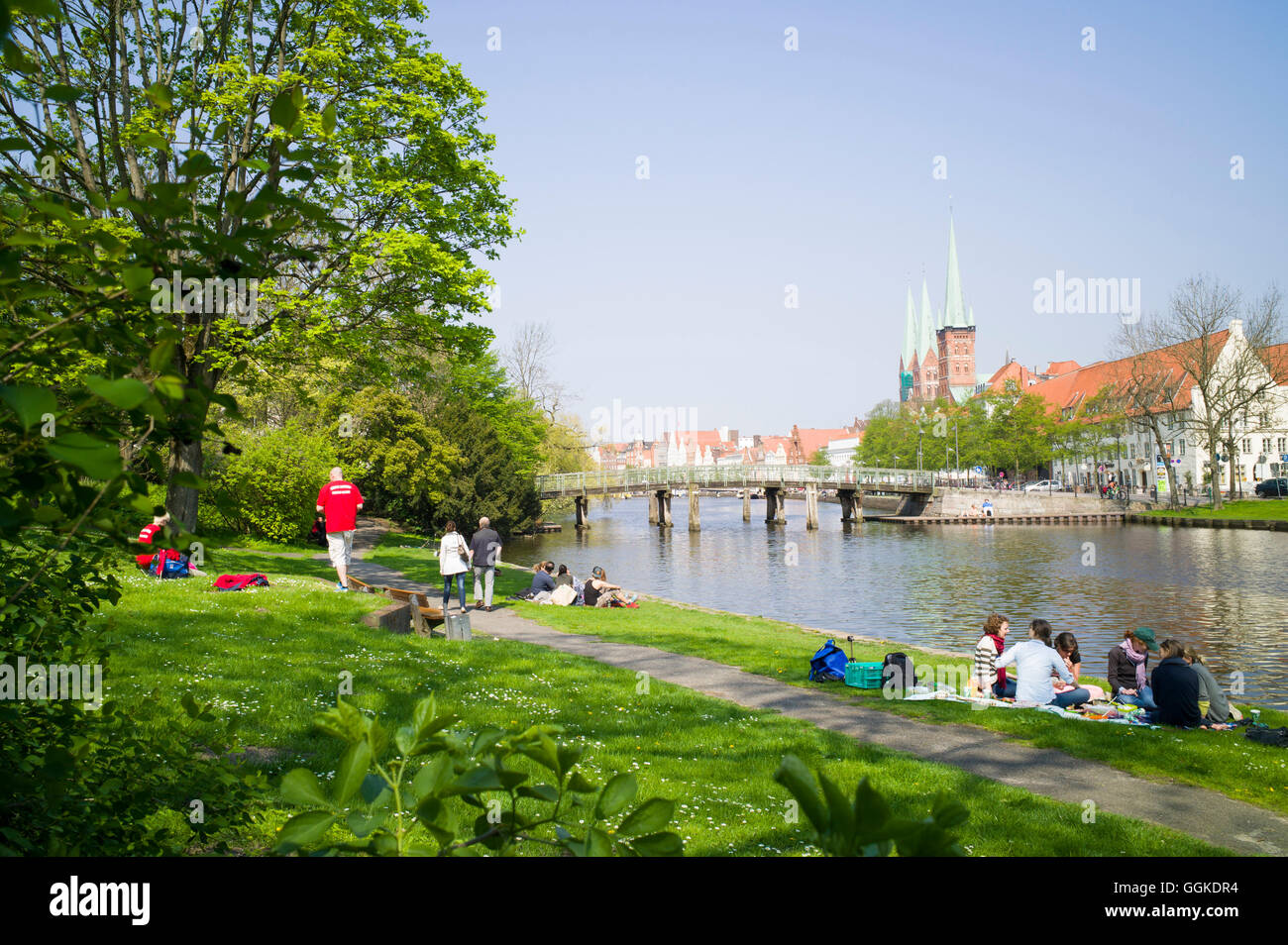 Lawn on river Obertrave with view to historic city, Lubeck, Schleswig-Holstein, Germany Stock Photo