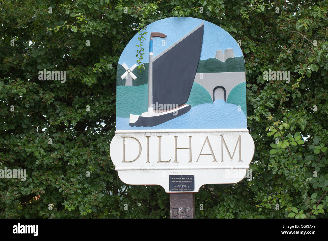 Village Sign. Dilham. Norfolk. East Anglia. England. UK. Depicting Windpump, Windmill, Brick Kilns, canal bridge, Wherry. Stock Photo