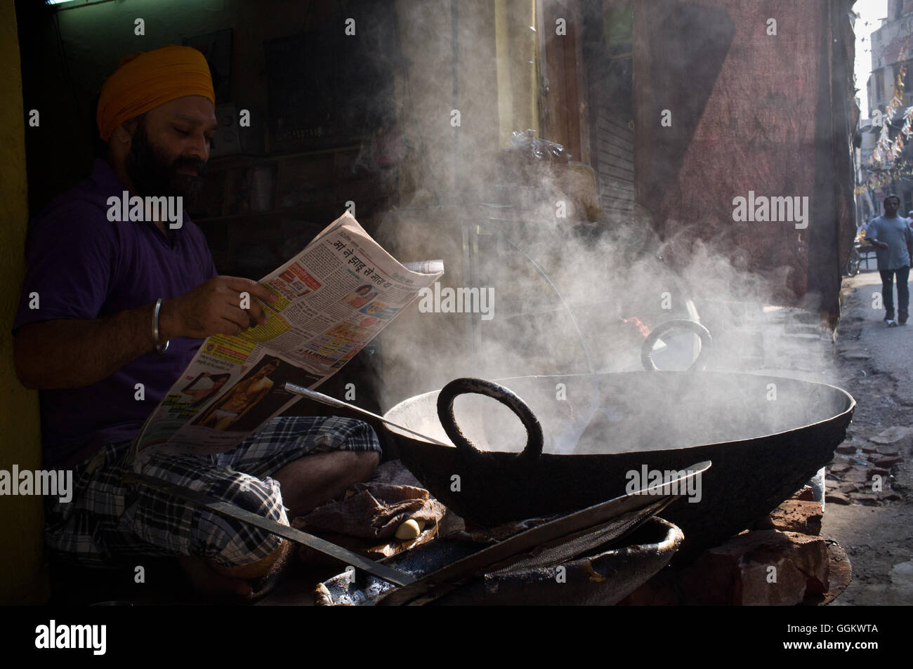 An indian food street vendor reads the newspaper early in the morning in Amritsar, India. © Jordi Boixareu Stock Photo