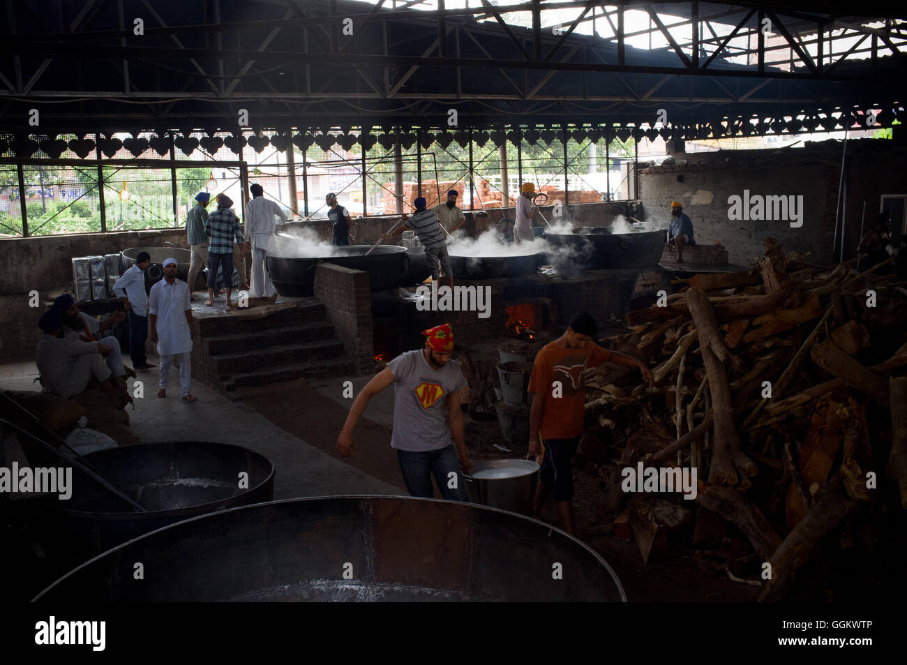 Volunteers prepare food for  worshippers and pilgrims in the kitchen of the Golden Temple complex in Amritsar. © Jordi Boixareu Stock Photo