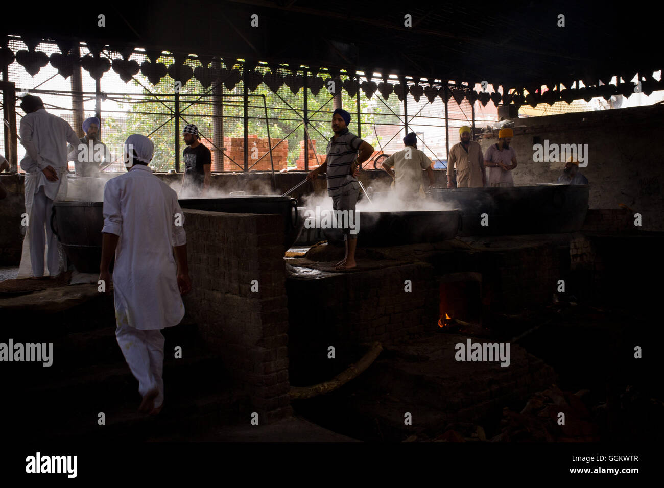 Volunteers prepare food for  worshippers and pilgrims in the kitchen of the Golden Temple complex in Amritsar. © Jordi Boixareu Stock Photo