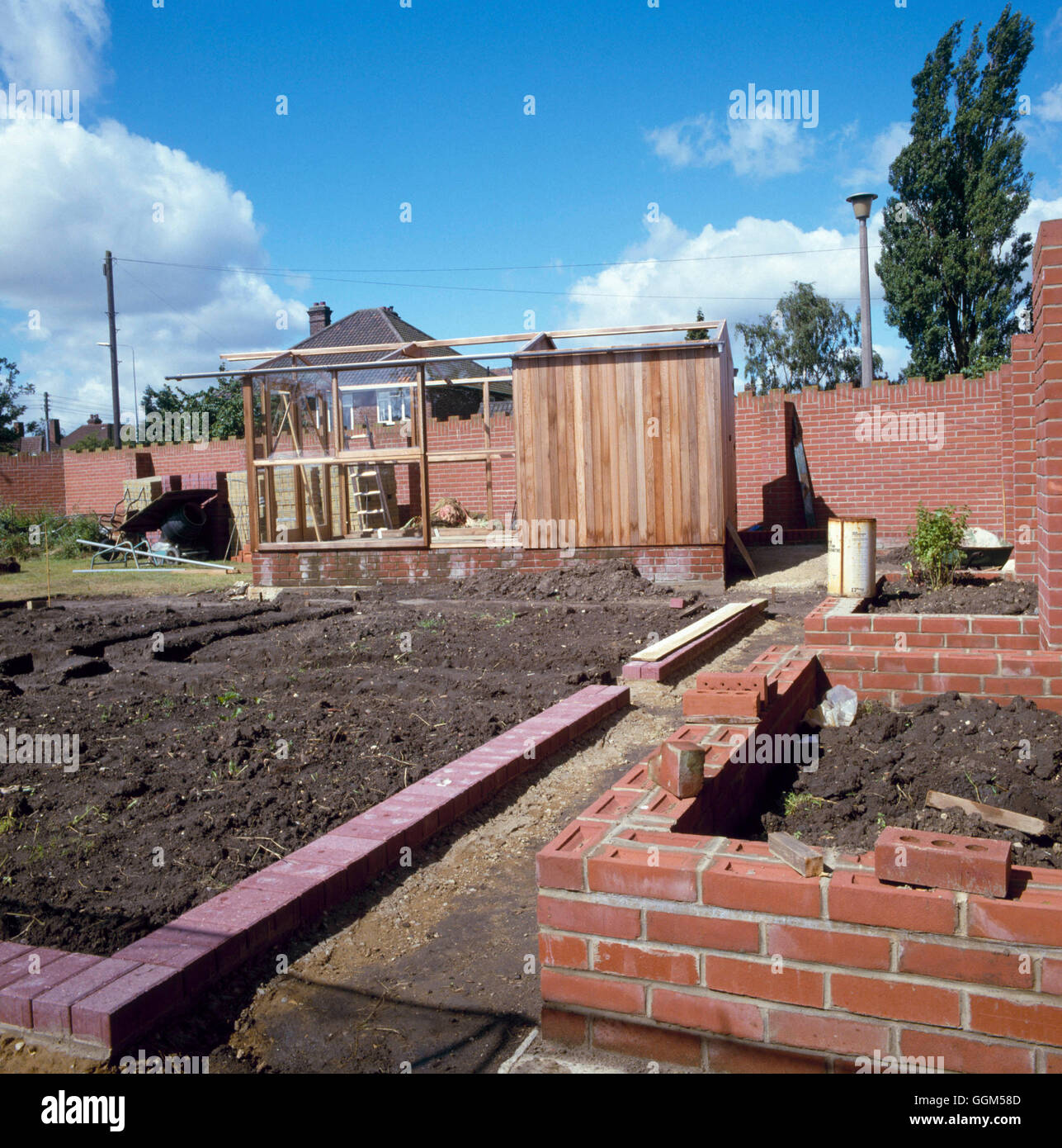 Landscaping - Raised beds under construction  path/bed edge being set   TAS009181     Photos Horticu Stock Photo