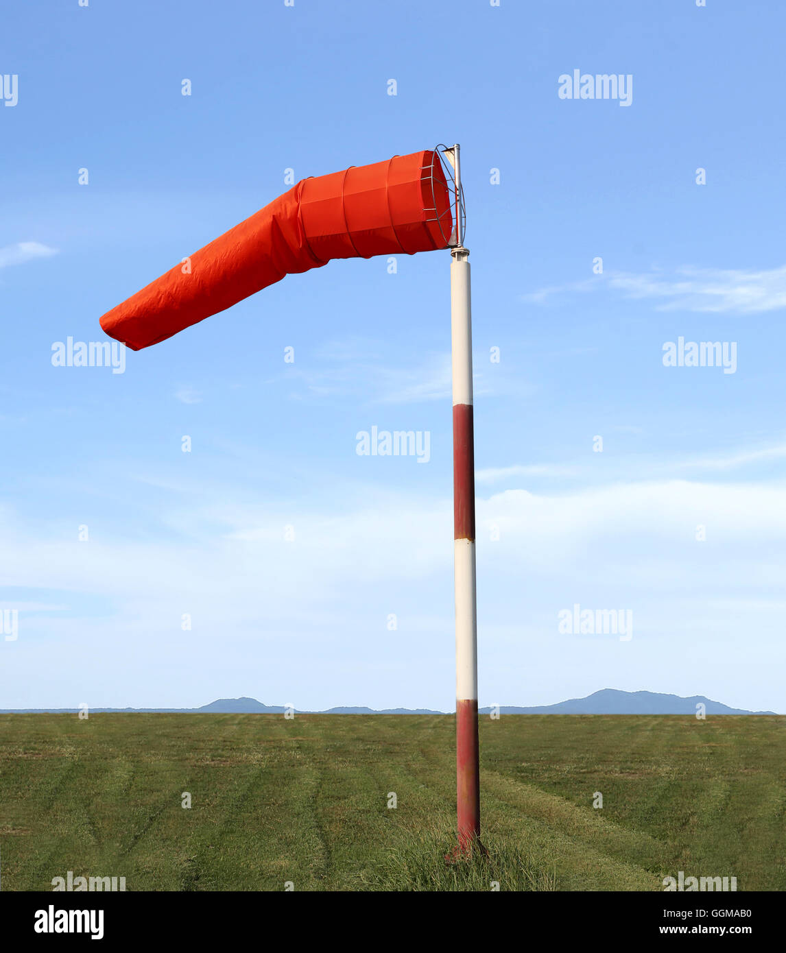 Wind sock of equipment check the wind blow direction in day time on blue sky background. Stock Photo