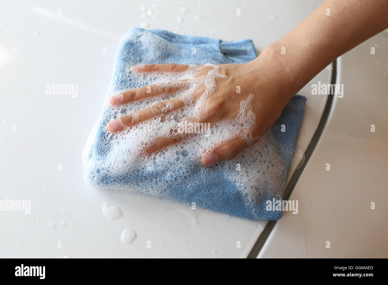 Women Hand in Wash a car with Microfiber Cloth for design Concept Cleaning vehicle Stock Photo