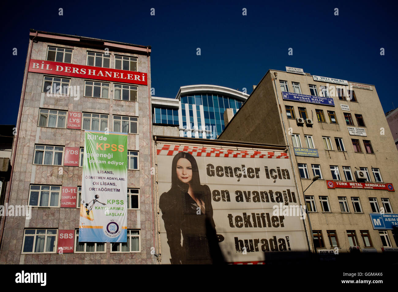 A woman is seen at an advertising sign on the facade of a building in Kayseri, Turkey. © Jordi Boixareu Stock Photo
