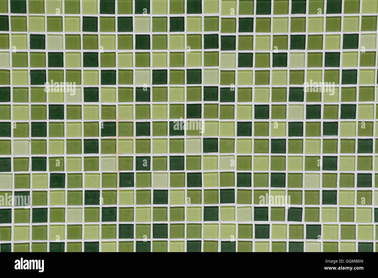 Toilet Wall of made of different hues in green tiles for the design background. Stock Photo