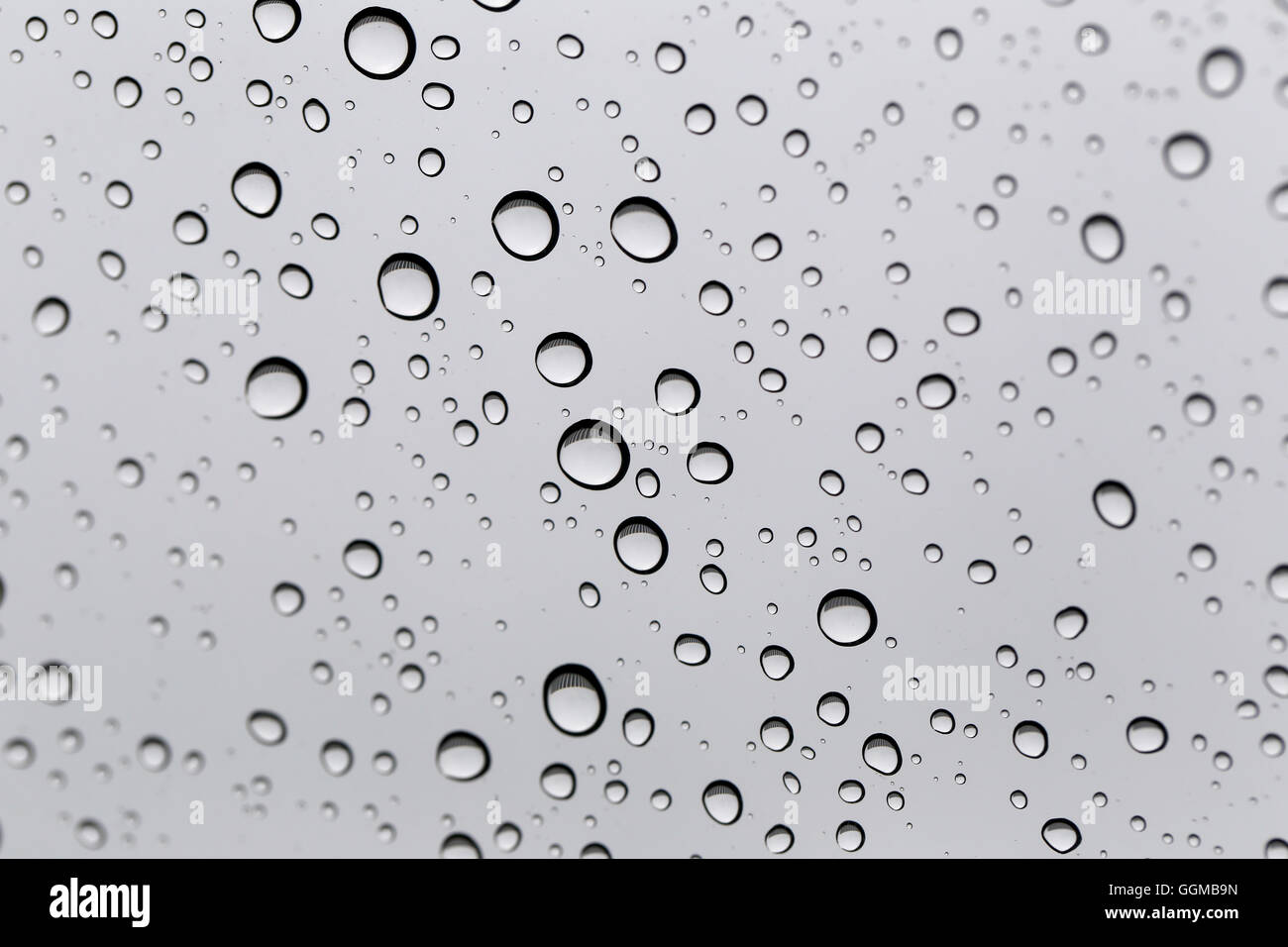 Drop of water for the background on glass car window to abstract design and nature backdrop. Stock Photo