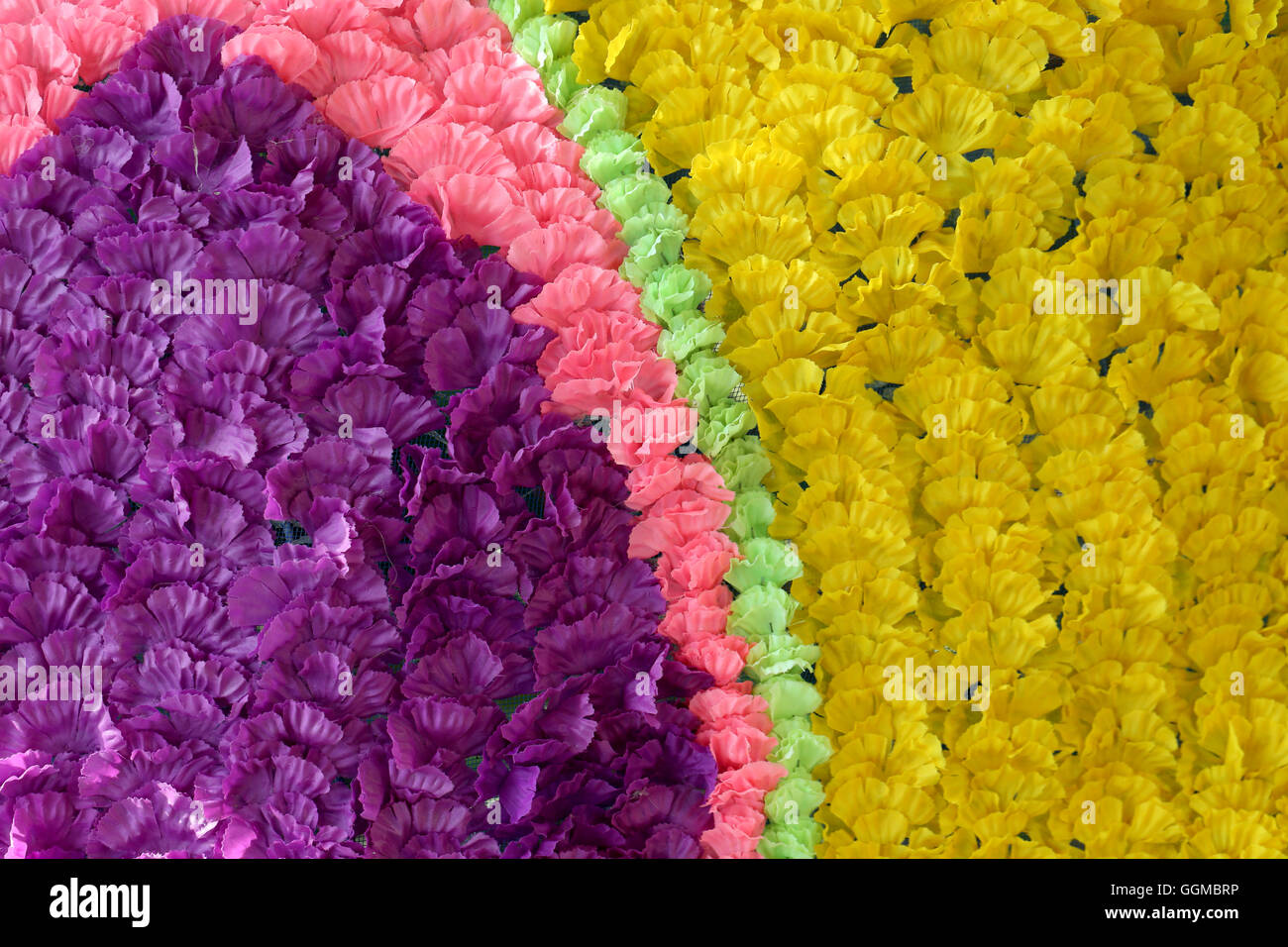 Background of colorful fake flowers that decorated the backdrop for the