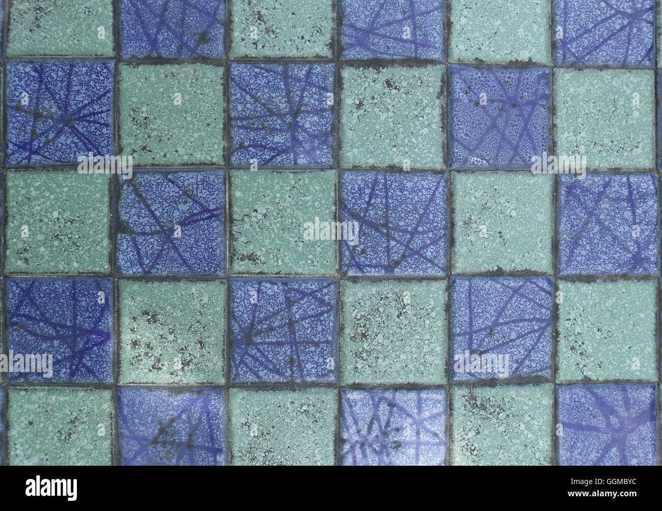 Old grunge wall tiles of the building texture mix color for the design background. Stock Photo