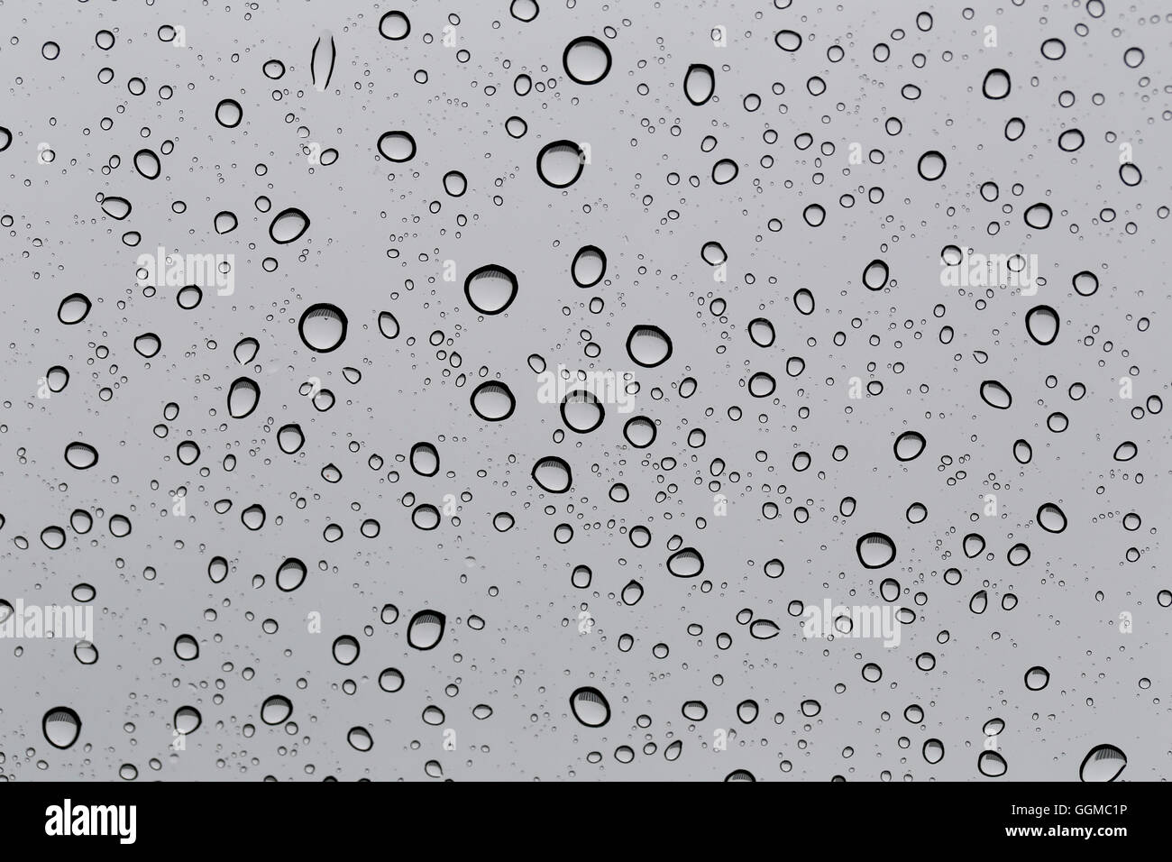 Drop of water for the background on glass car window to abstract design and nature backdrop. Stock Photo