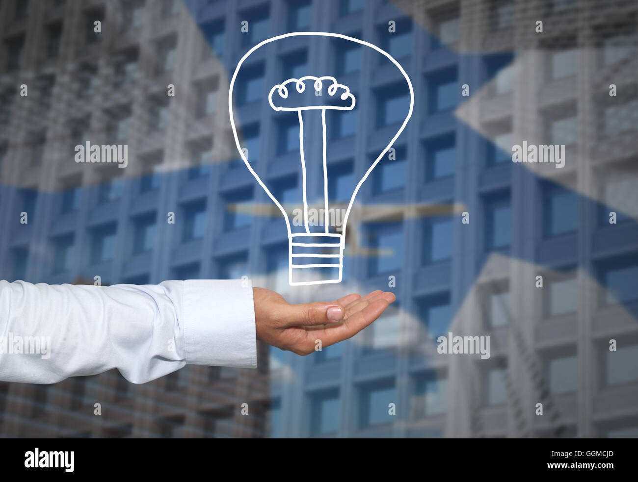 Drawing graphics lamp or bulb on hand to concept Creativity of new ideas in business and have skyscraper background. Stock Photo