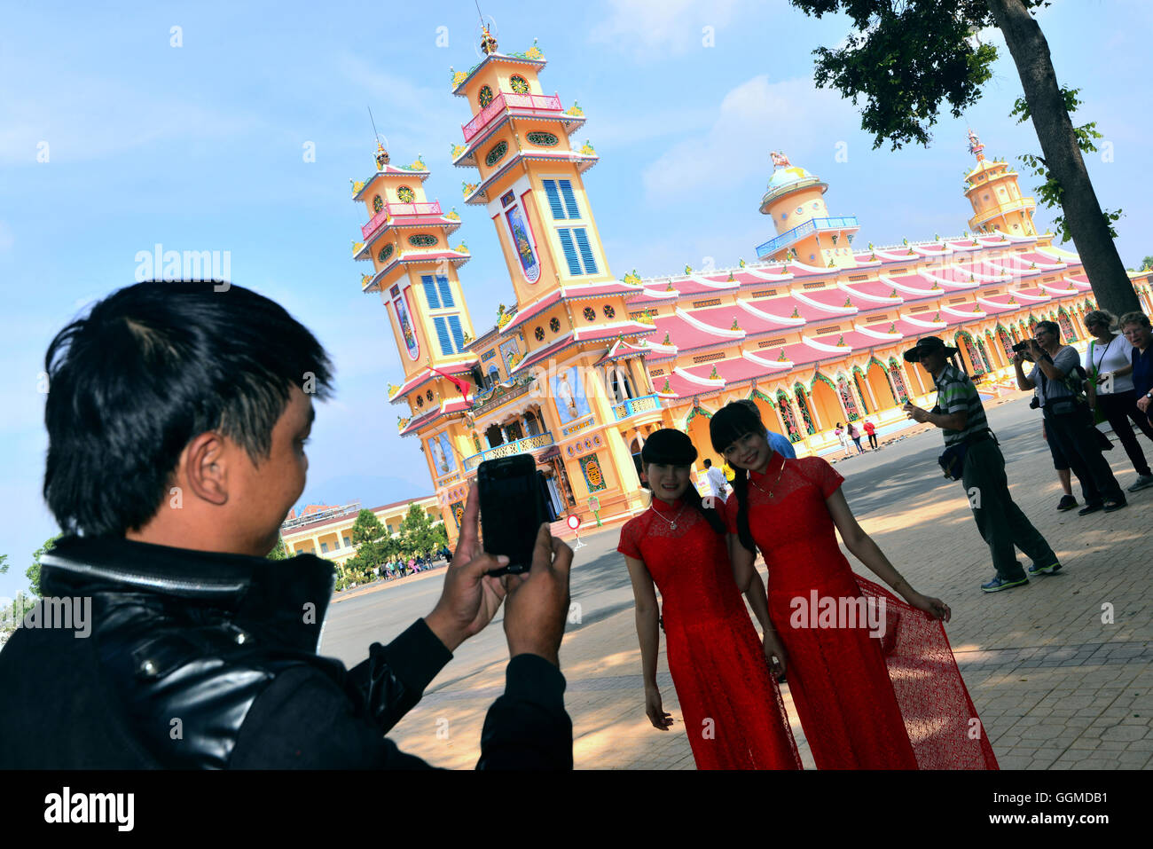 Man taking photos at the cathedral of Tay Ninh, Vietnam, Asia Stock Photo