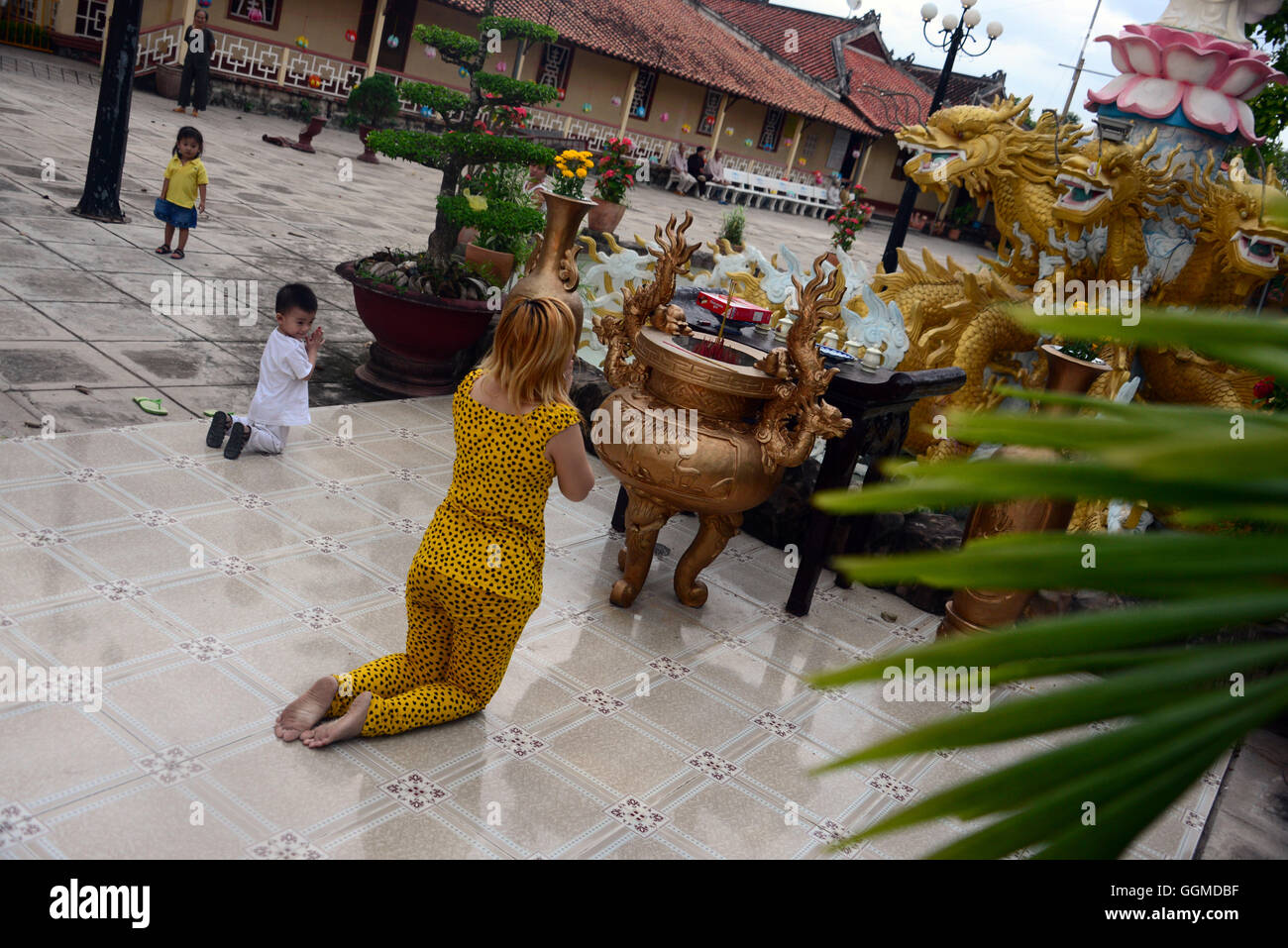 People praying in the temple, An Binh in the delta of Mekong river, Vietnam, Asia Stock Photo