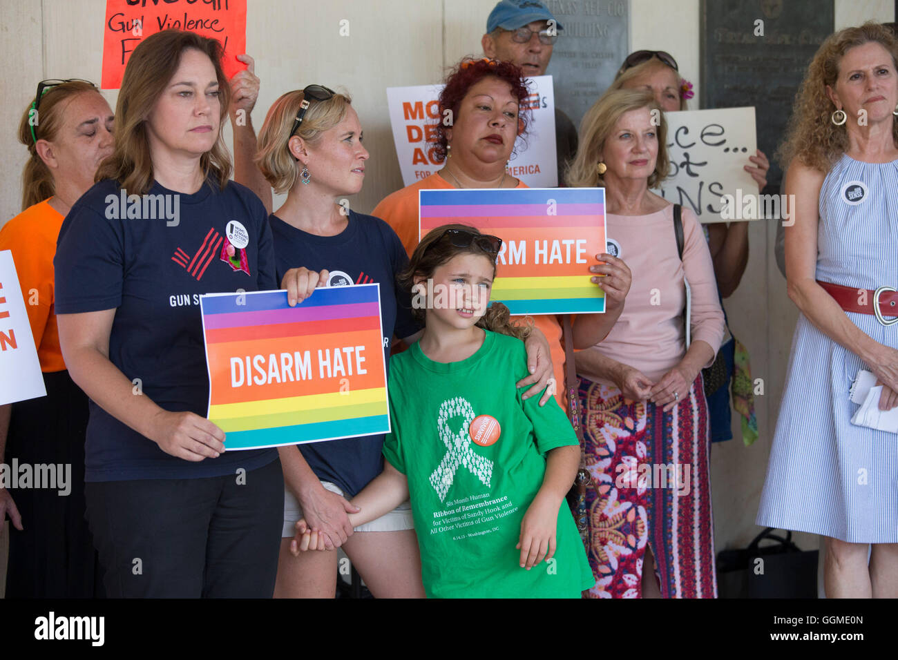 Activists hold anti-gun violence signs at rally outside AFL-CIO headquarters in Austin, Texas, featuring victims of gun violence Stock Photo