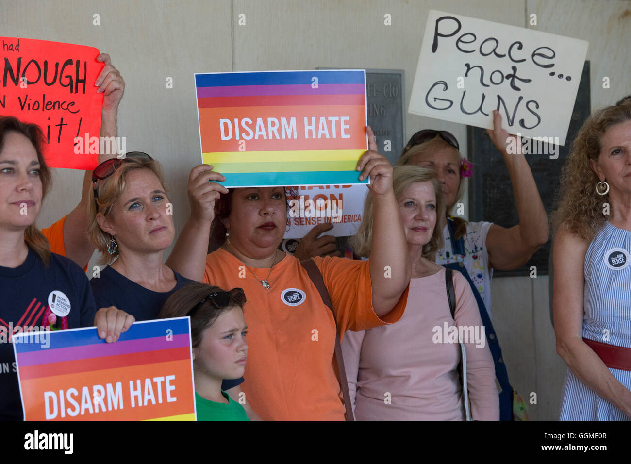 Activists hold anti-gun violence signs at rally outside AFL-CIO headquarters in Austin, Texas, featuring victims of gun violence Stock Photo