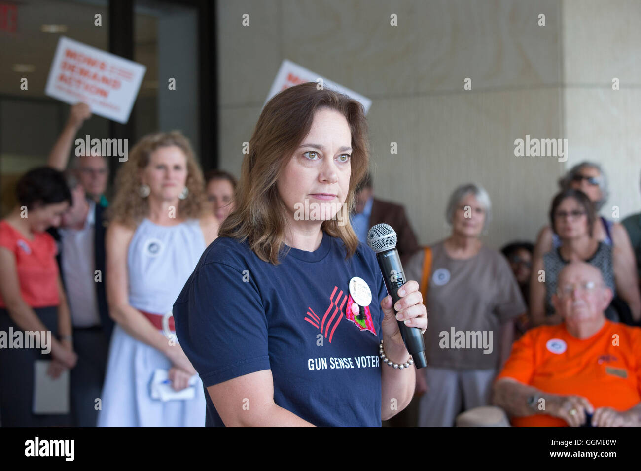 Woman speaks as anti-gun violence rally outside AFL-CIO headquarters in Austin, Texas, featuring victims of gun violence Stock Photo