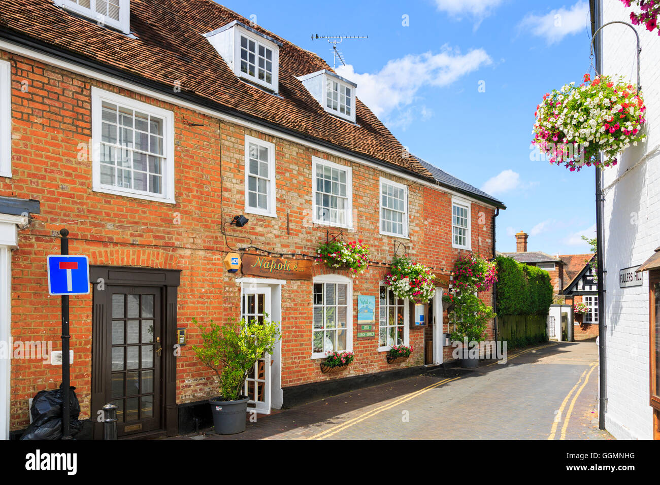 Typical red brick buildings and restaurant in Westerham, a town in the Sevenoaks District, Kent, on a sunny day with blue sky in Stock Photo