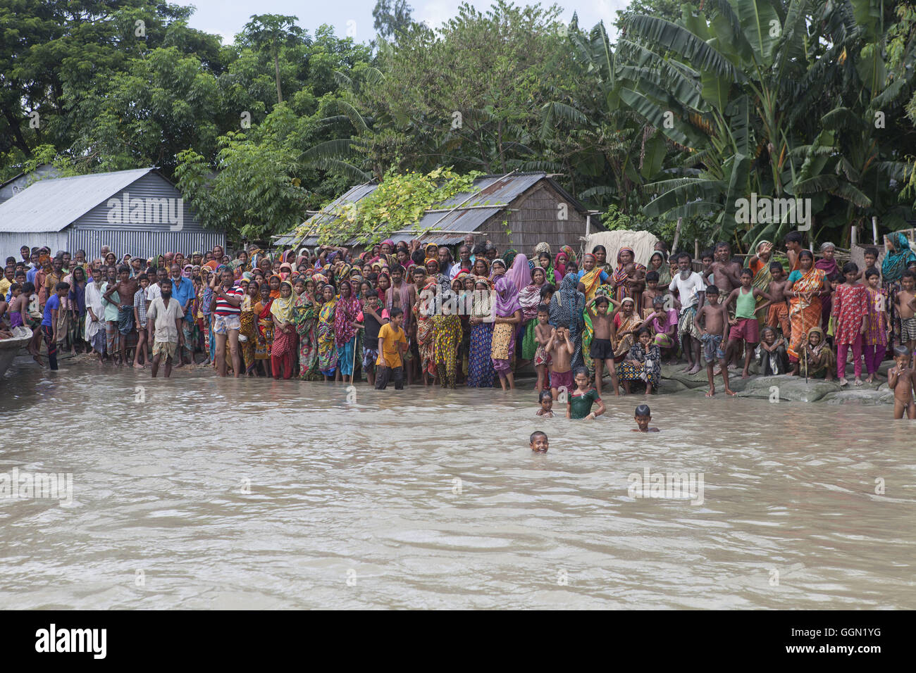 August 2, 2016 - Jamalpur, Mymensingh, Bangladesh - Villagers are waiting for a relief boat in Islampur, Jamalpur. According to the Bangladesh Disaster Management Bureau around 1.5 million people have been affected by this year flood. Rivers in the north started to rise in early July and by the 20th of July nearly all of them started to flow over the danger level. It caused floods in 6 districts, namely, Lalmonirhat, Kurigram, Gaibandha, Jamalpur, Sirajganj and Sunamganj initially and inundated crop fields and dwelling areas, washed away standing crops, houses and householdâ€™s assets, livesto Stock Photo