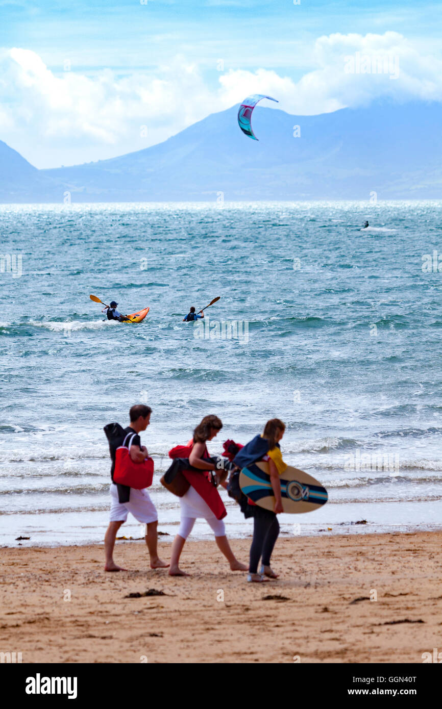 Skimboarders, canoeists and kite surfer all enjoying the warm weather