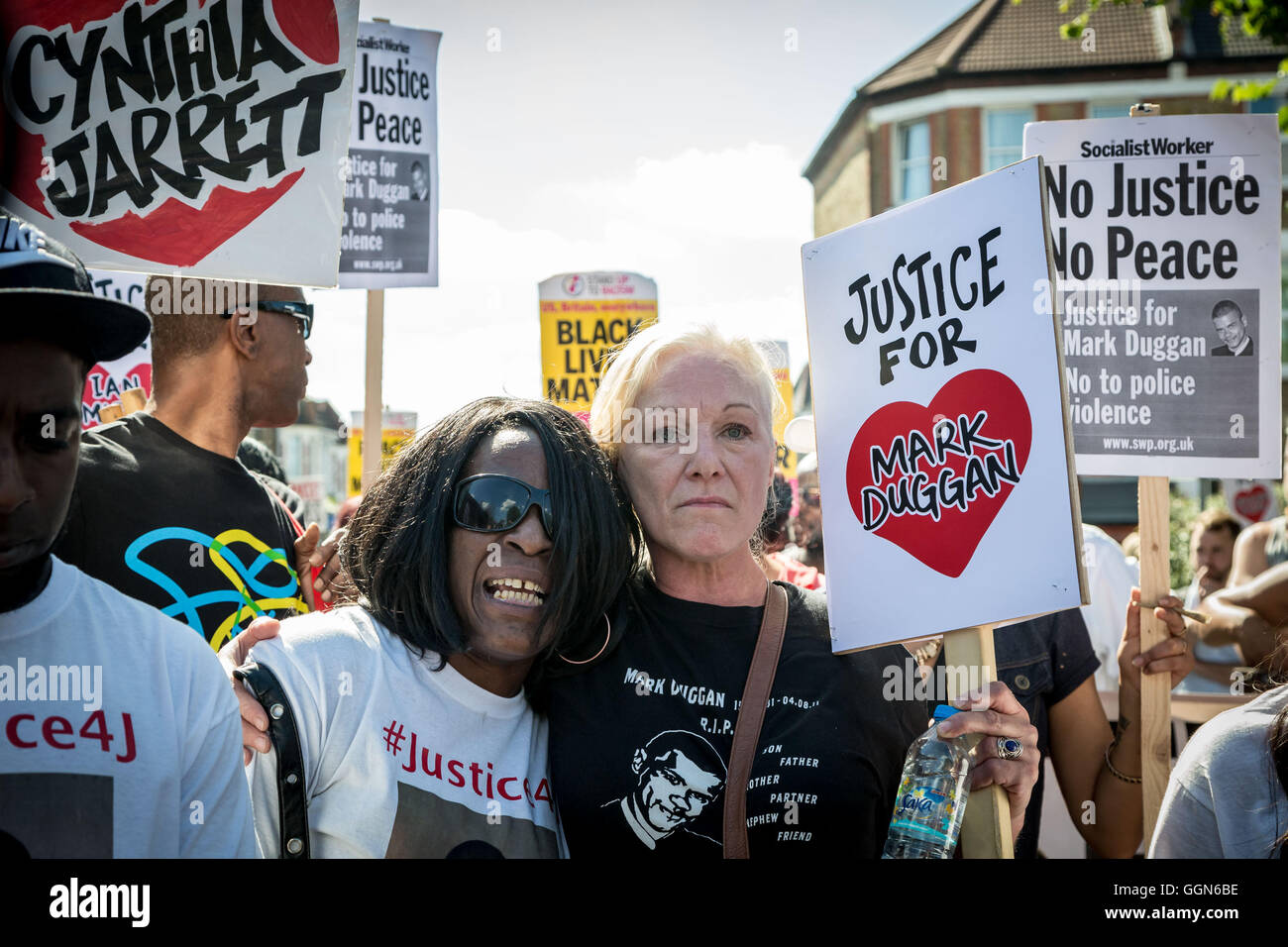 London, UK. 6th August, 2016. Carole Duggan, aunt of Mark, hugs the mother of Jermaine Baker during a march from Broadwater Farm Estate through north London to mark the fifth anniversary of the death of Mark Duggan in a police shooting that sparked riots across the capital in 2011 Credit:  Guy Corbishley/Alamy Live News Stock Photo