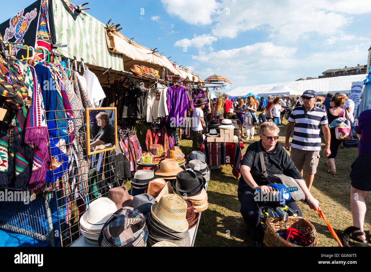 Broadstairs folk week festival. People strolling around market and tented craft stalls in