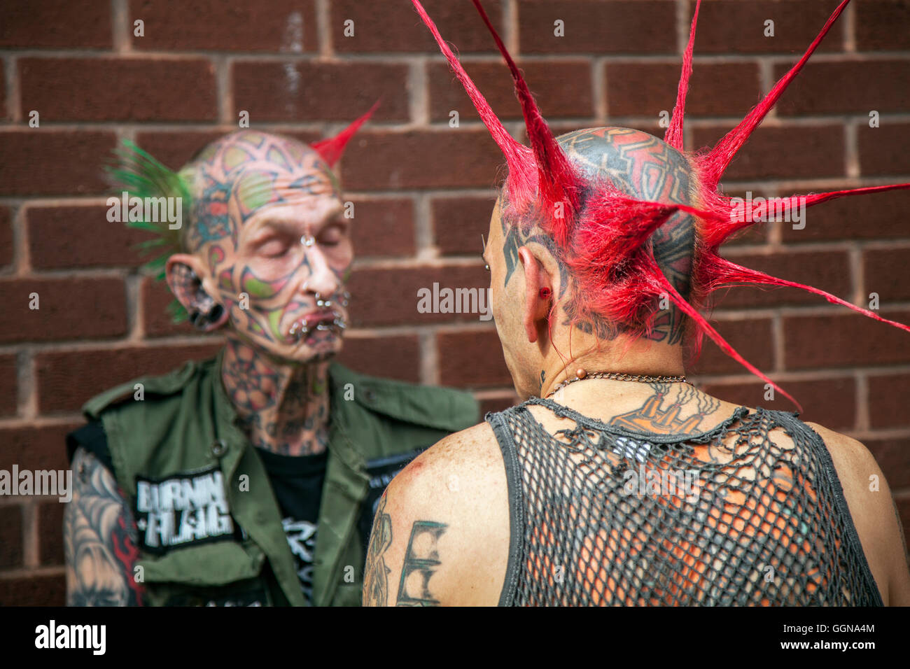 Couple Skinheads, Blackpool, Lancashire, UK. 6th August, 2016. 'Webber' with nose piercing at the 20th anniversary Rebellion fest returned to Blackpool Winter Gardens as one of the world’s biggest punk festivals.  Spiky-haired punks gathered at the UK’s biggest alternative music festival. The Rebellion Festival sees hard rocking punk bands take to the stage at Blackpool’s Winter Gardens every year to the delight of cheering crowds. The resort’s streets are painted every colour of the rainbow as lifelong punk fans with vividly dyed Mohawks, leather jacketsflock to the resort. Stock Photo