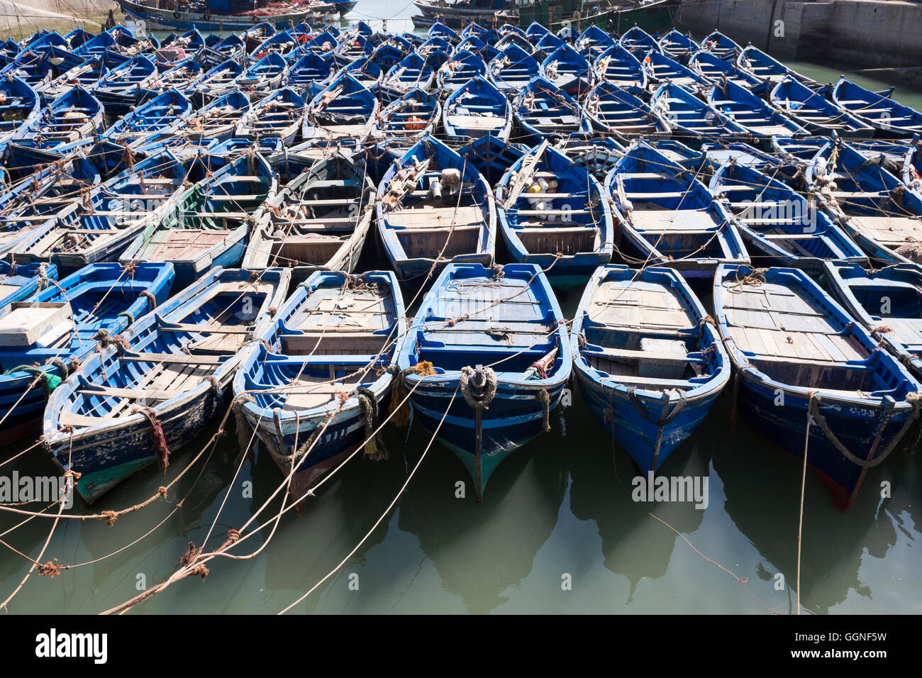 Blue boats secured with rope Stock Photo