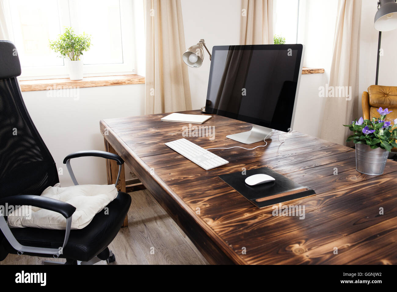 Computer on table in home office Stock Photo - Alamy