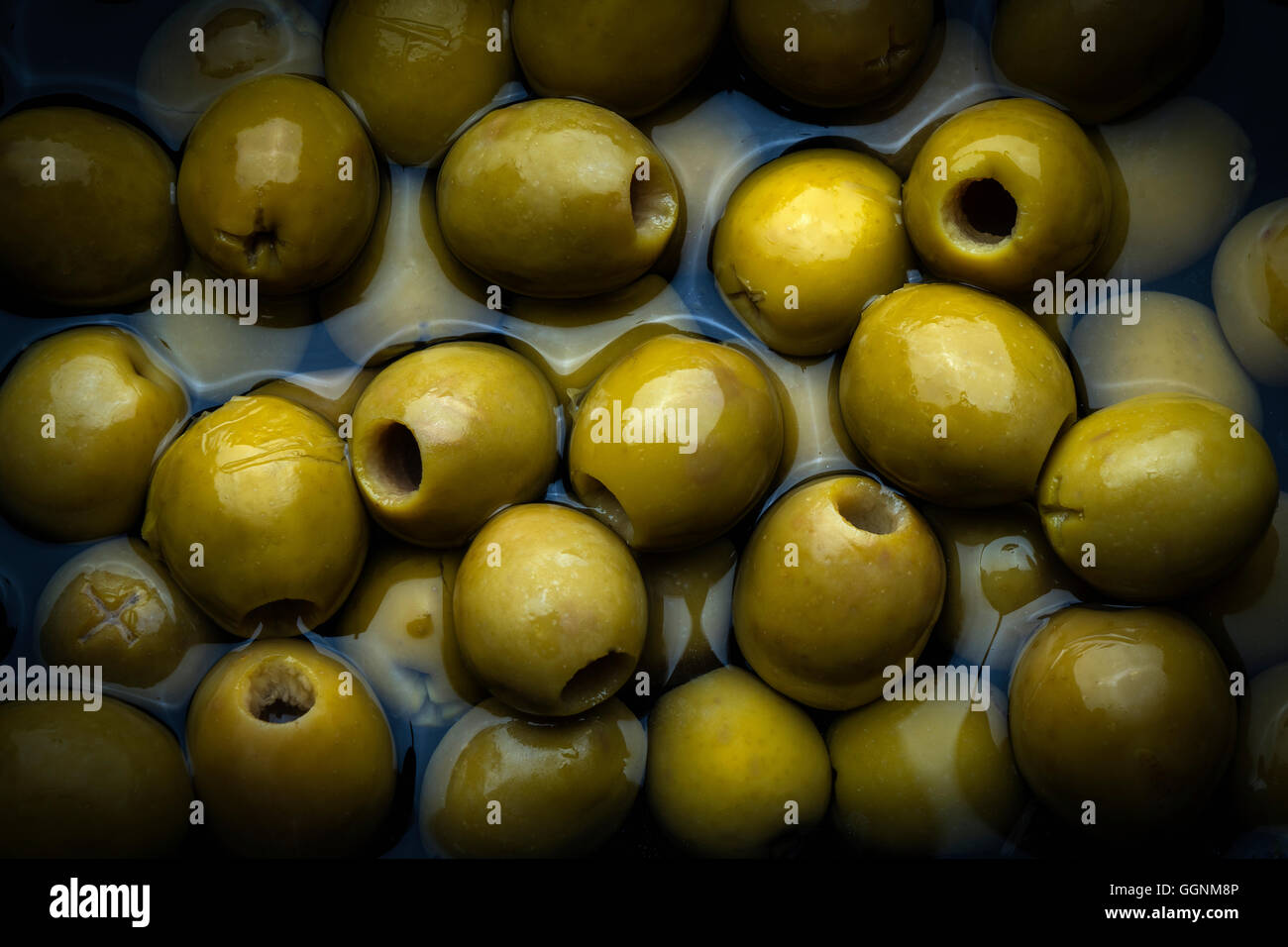 Green olives in liquid Stock Photo Alamy