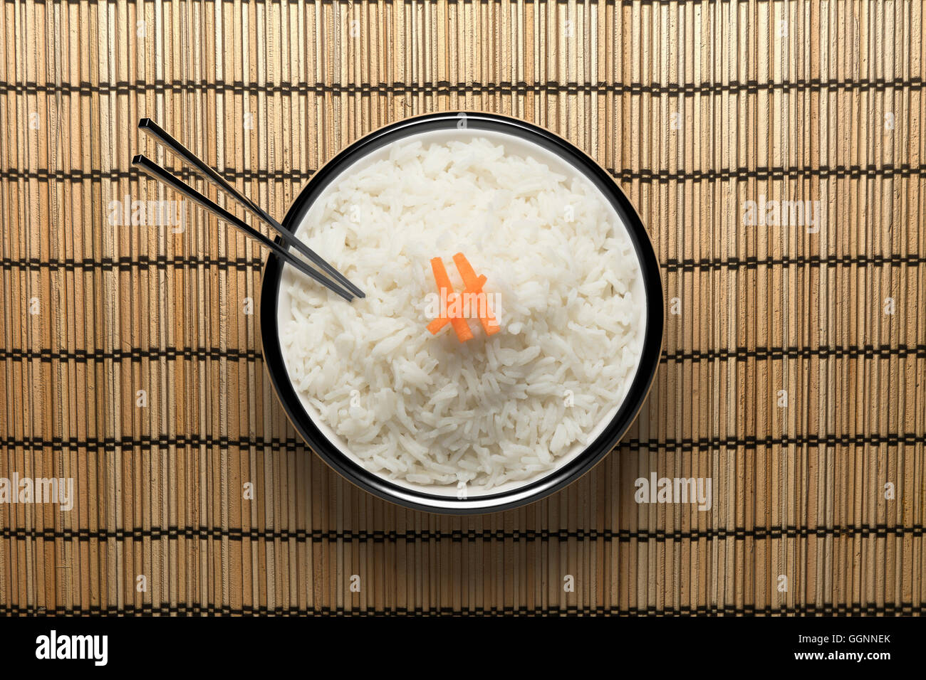 Chopsticks in bowl of white rice Stock Photo