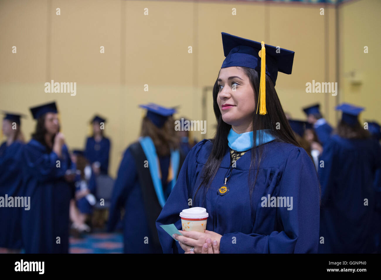 Graduation candidates in caps and gowns wait for Western Governors