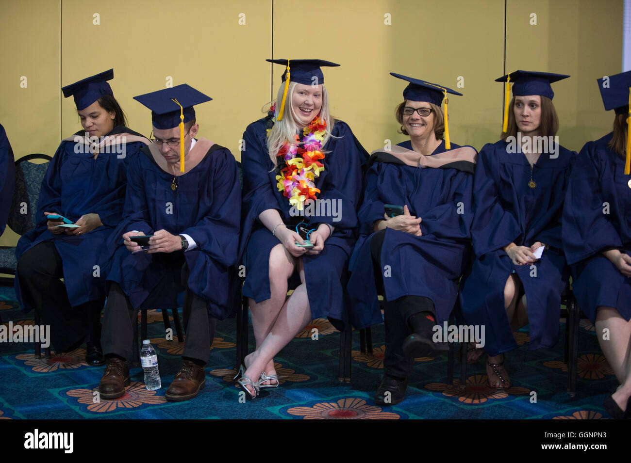 Graduation candidates in caps and gowns wait for Western Governors