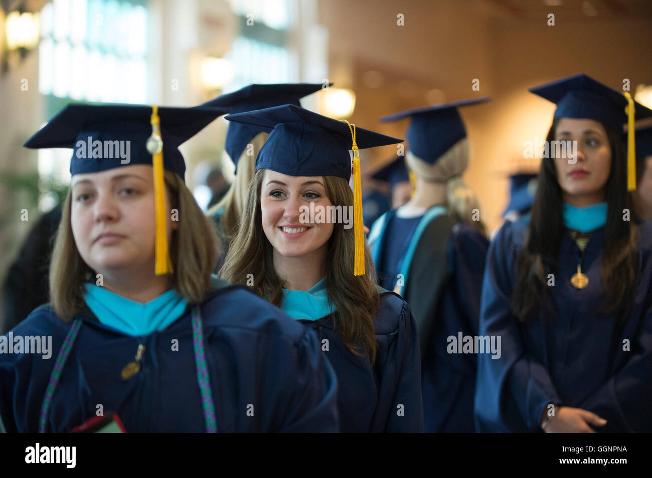 Graduation candidates in caps and gowns wait for Western Governors