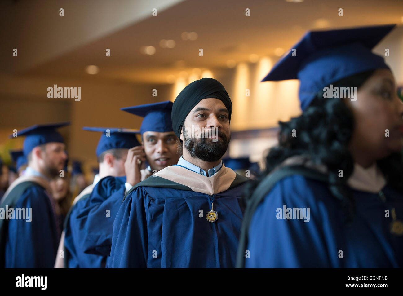 Graduation candidates in caps and gowns wait for Western Governors