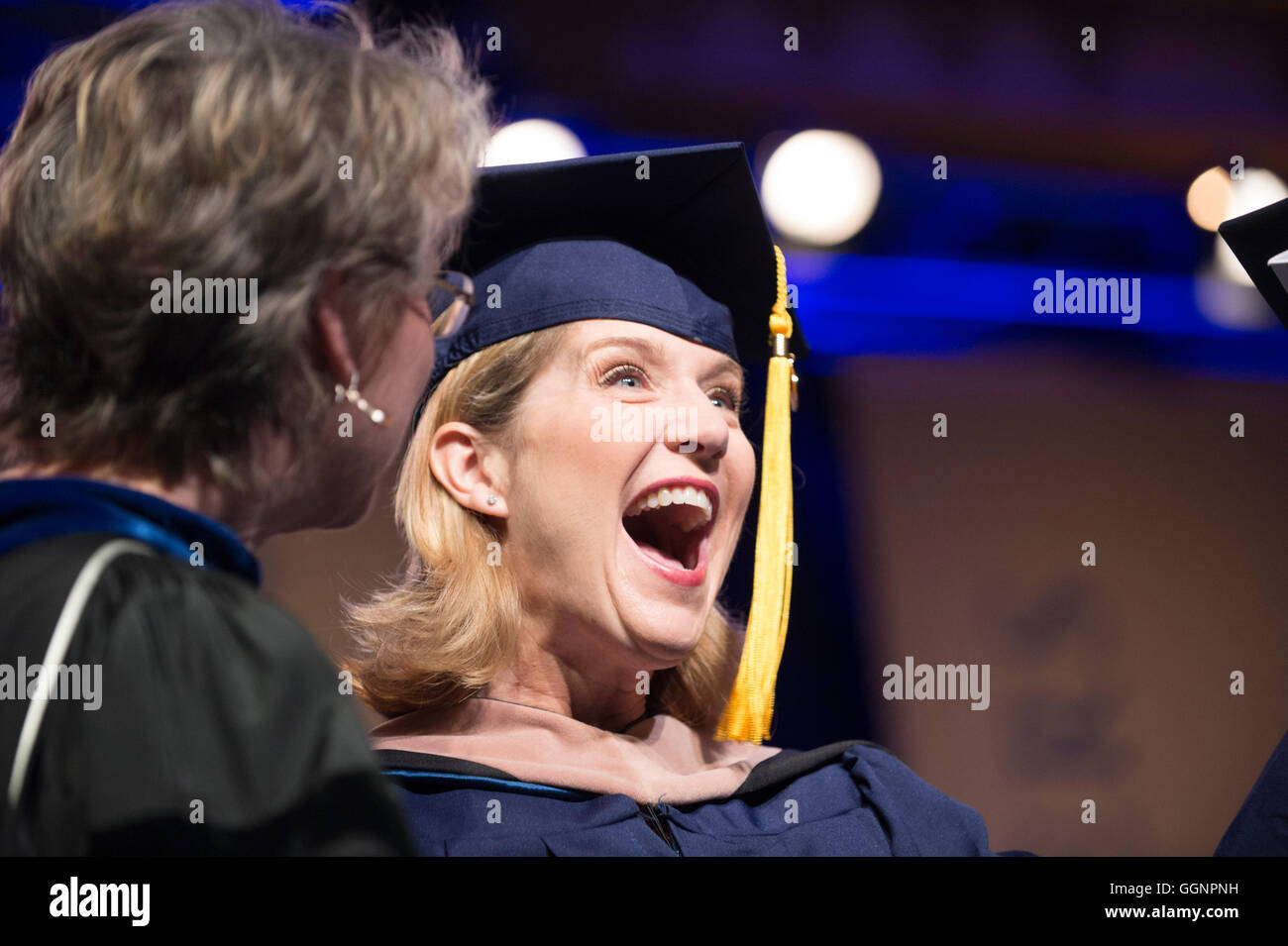 Graduate exults after receiving diploma during commencement ceremony for Western Governors University in Orlando, FL Stock Photo