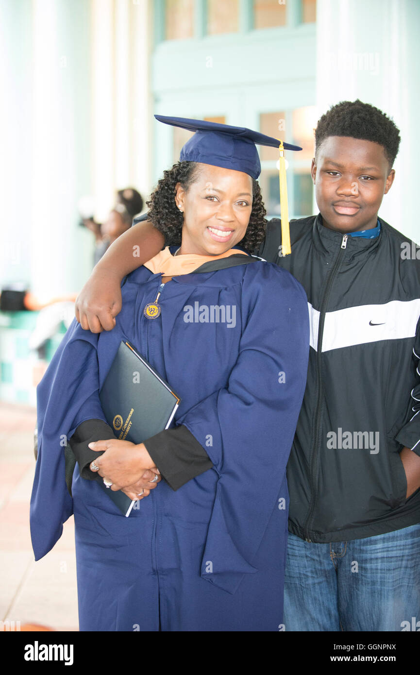 Graduate of Western Governors University poses with family member after