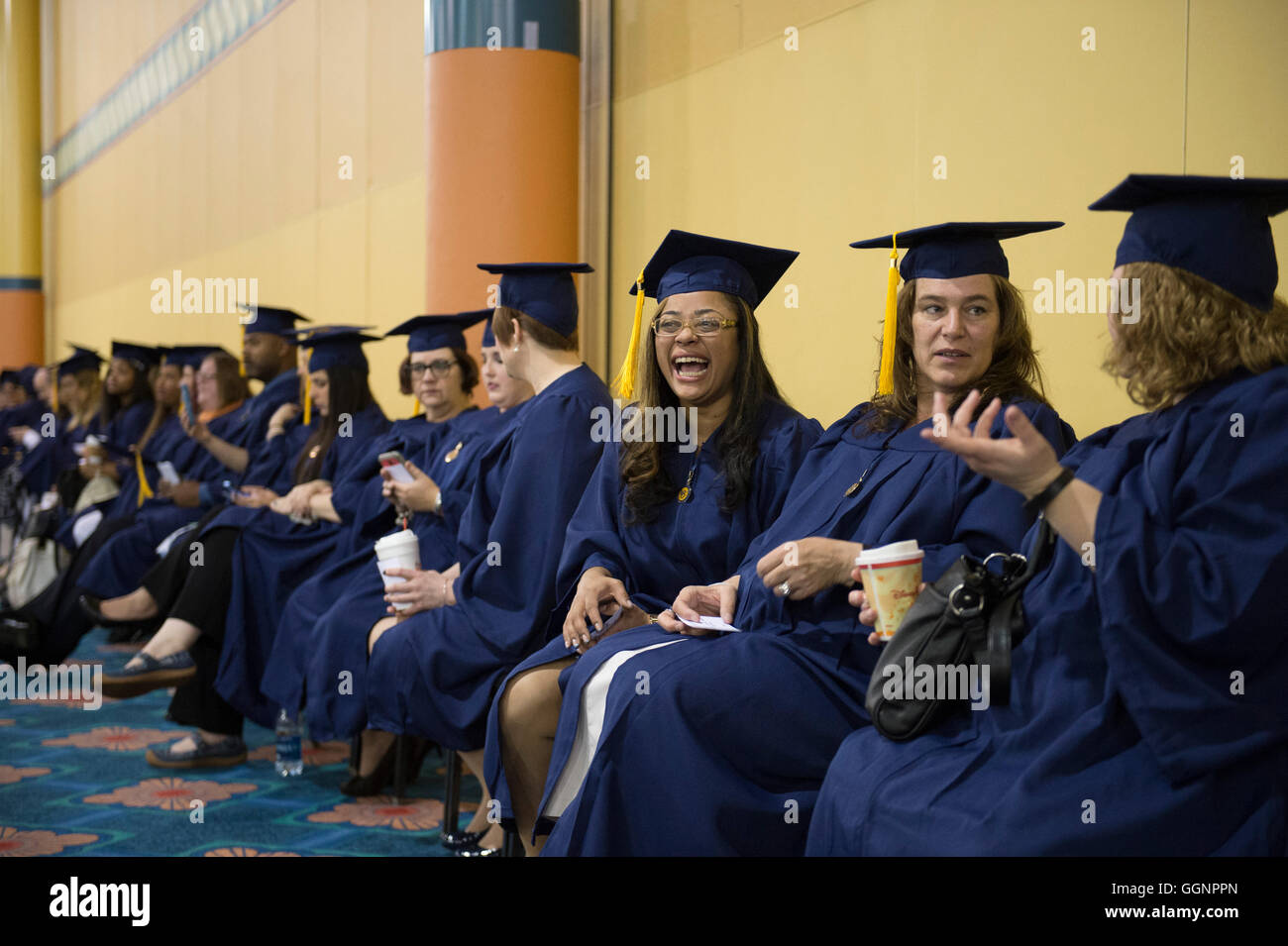Graduation candidates in caps and gowns wait for Western Governors