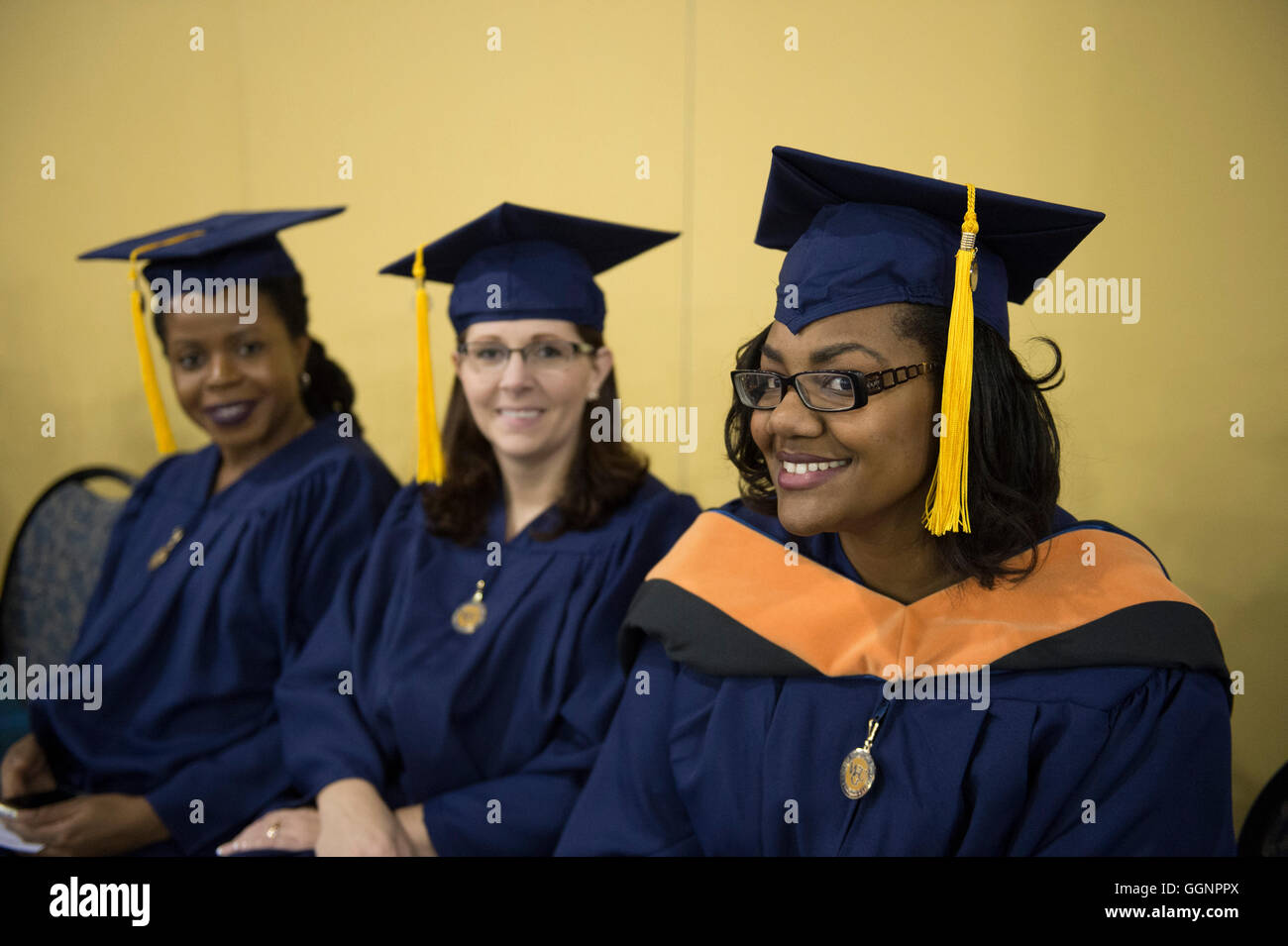 Graduation candidates in caps and gowns wait for Western Governors