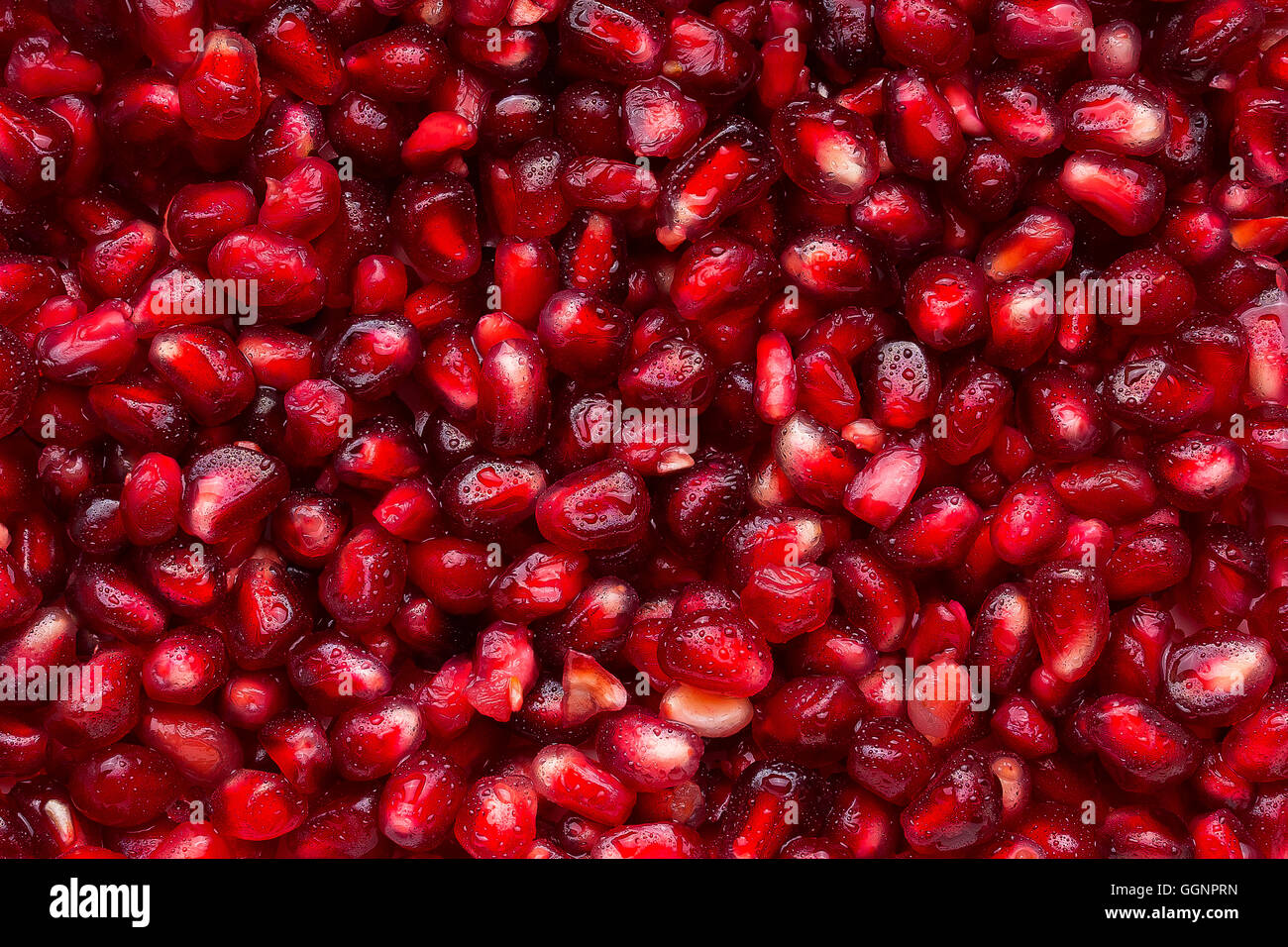 Pile of wet red pomegranate seeds Stock Photo