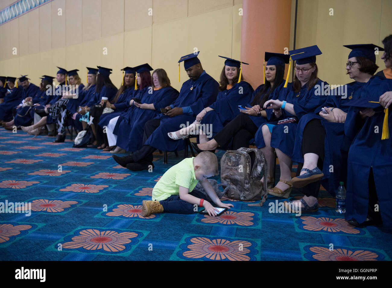 Graduation candidates in caps and gowns wait for Western Governors