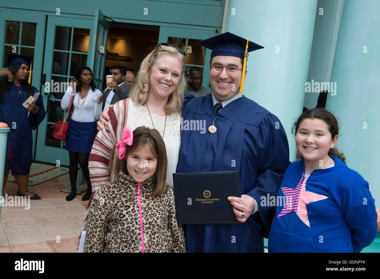 Family celebrates with graduate after commencement for Western Governors University, a fully accredited online university Stock Photo