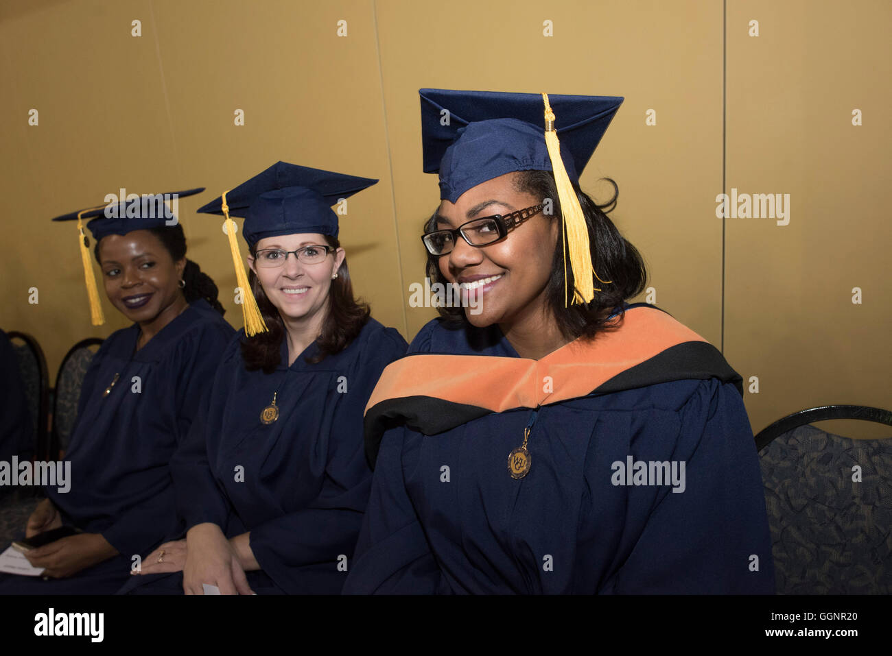 Graduation candidates in caps and gowns wait for Western Governors
