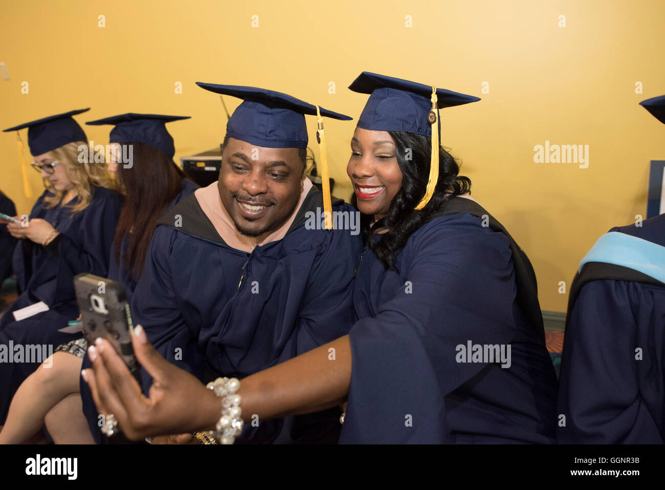 Graduation candidates in caps and gowns wait for Western Governors