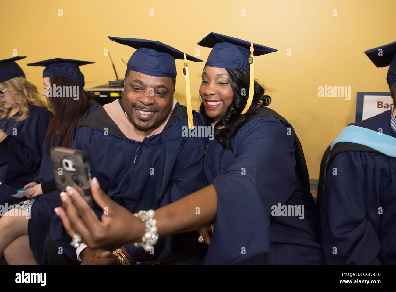 Graduation candidates in caps and gowns wait for Western Governors