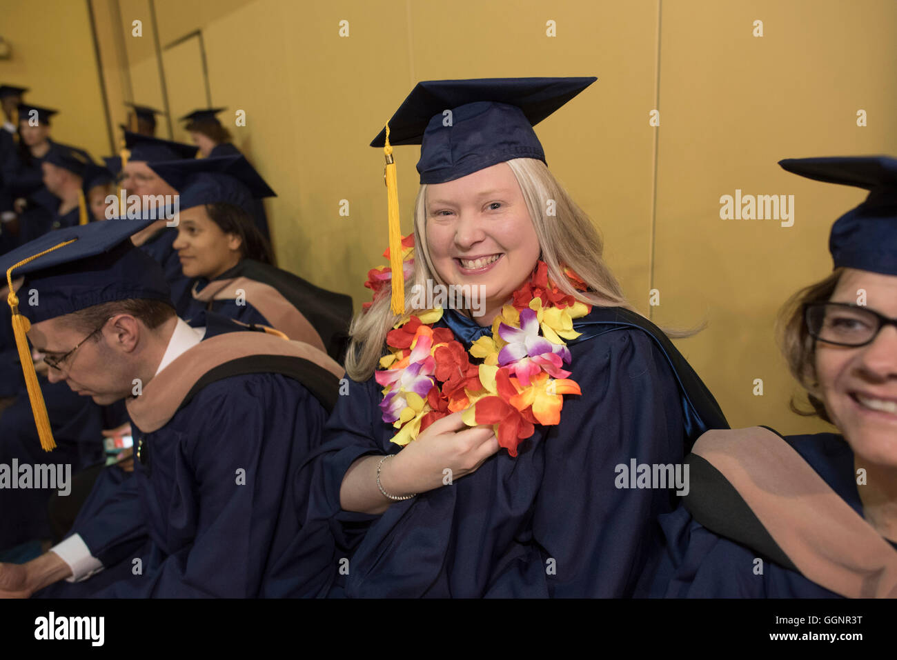 Graduation candidates in caps and gowns wait for Western Governors
