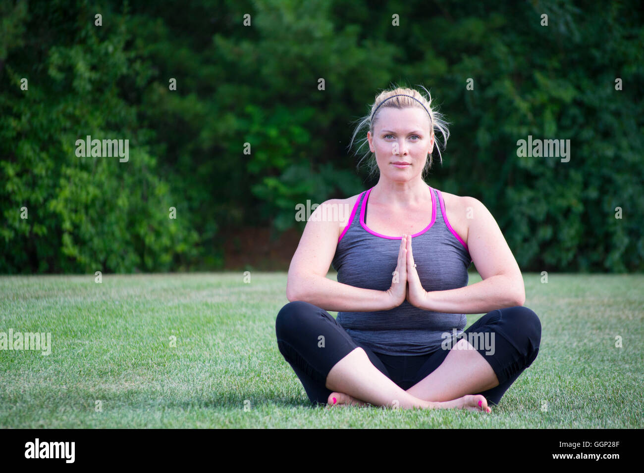 Young Woman sitting in yoga pose Stock Photo - Alamy