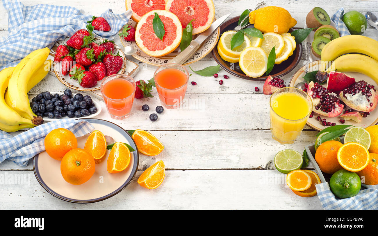 Citrus juice, fruits and berries on wooden background. Healthy eating, dieting. Top view Stock Photo