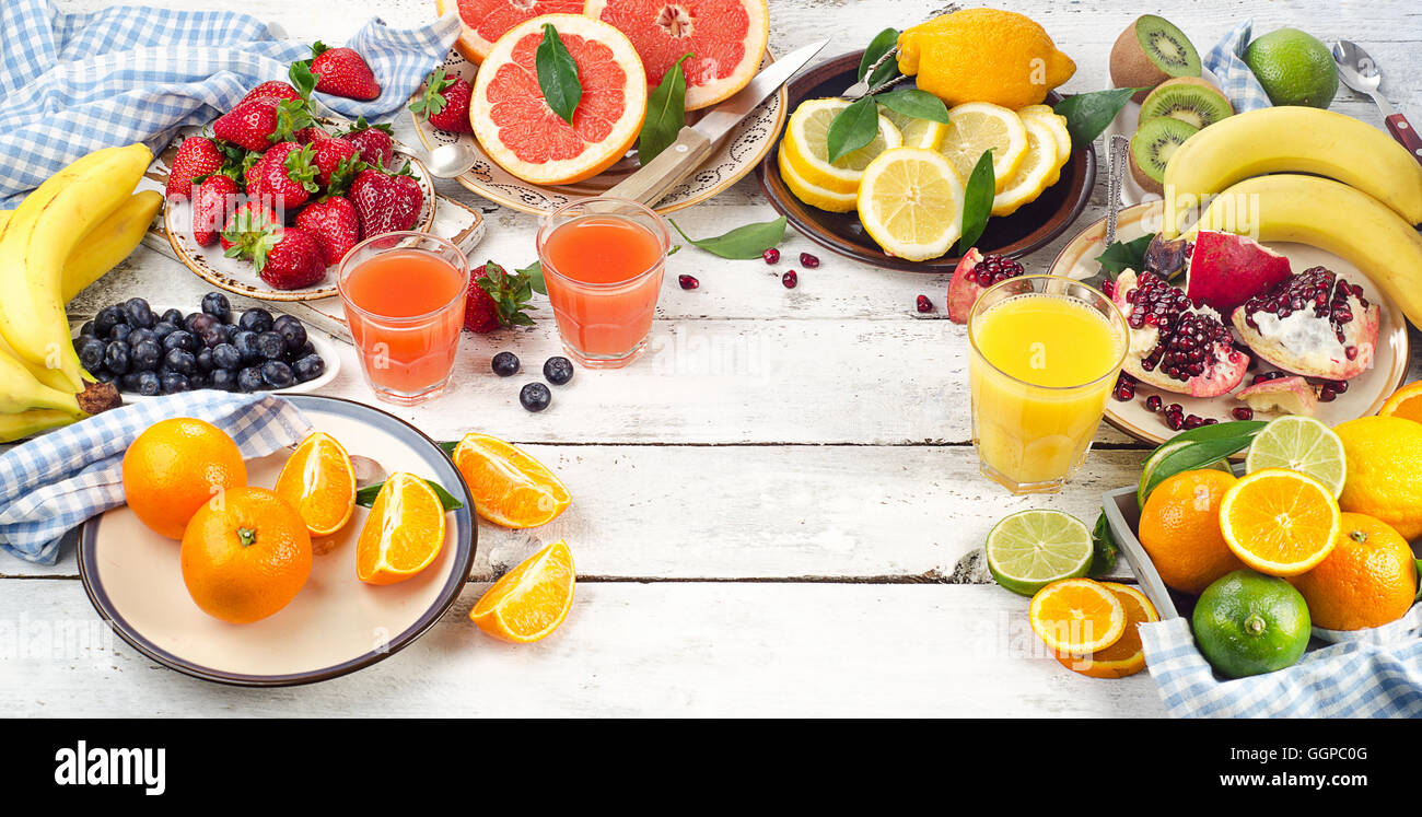 Citrus juice, fruits and berries on a wooden background. Healthy eating, dieting. Top view Stock Photo