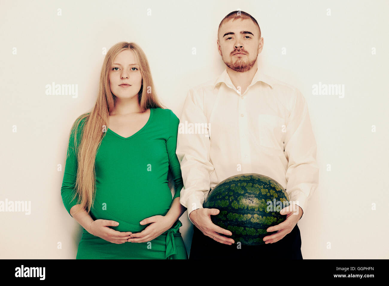 Man holding watermelon with pregnant girlfriend Stock Photo