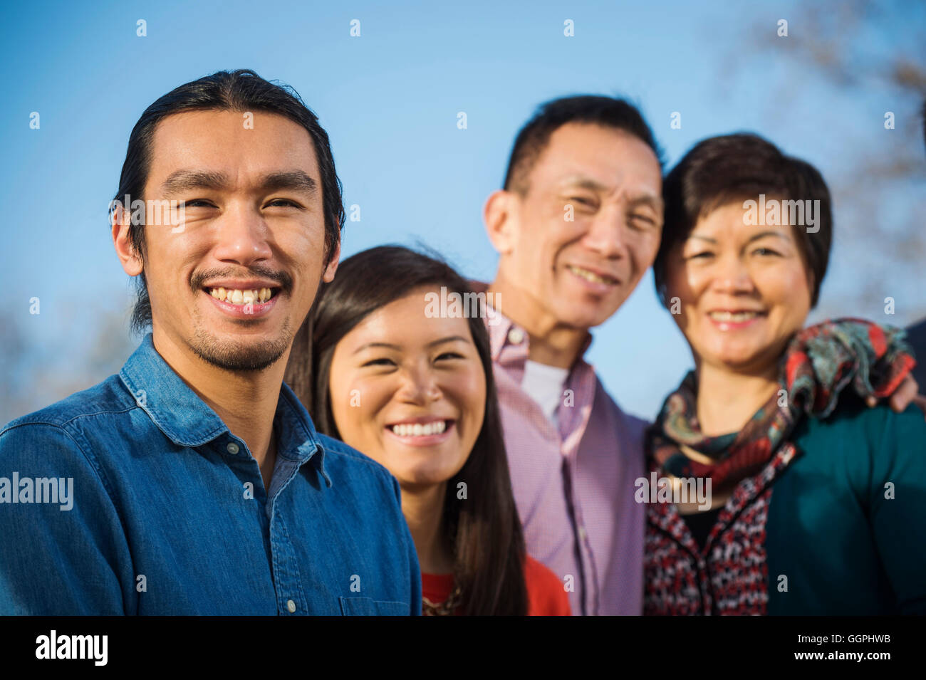 Chinese family smiling outdoors Stock Photo